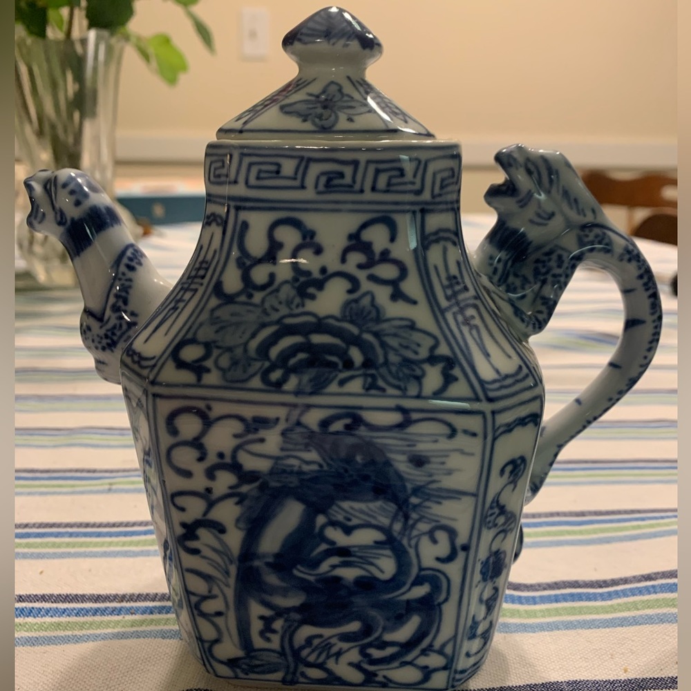Blue and white teapot with matching tea cup.